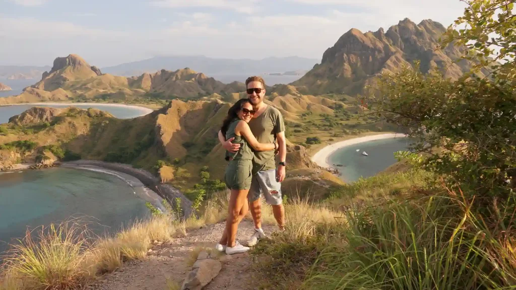 Couple at the Padar Island viewpoint above Komodo's crescent bays