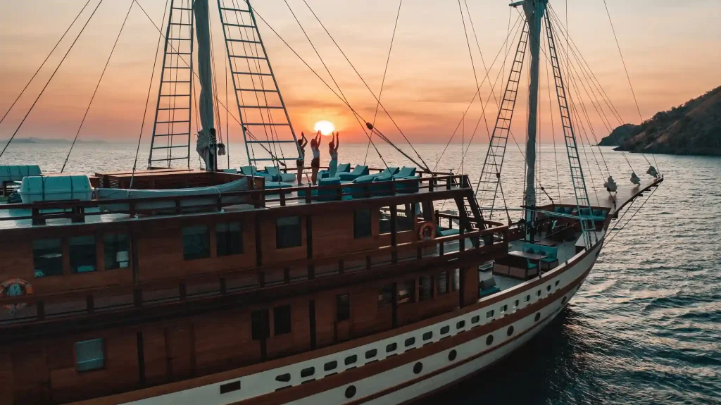Teak deck and rigging of a wooden phinisi at sunset