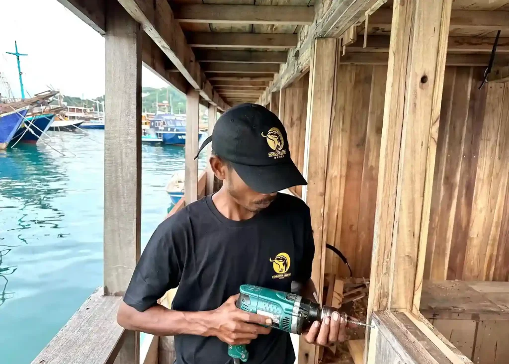 Craftsman working on boat construction in a timber workshop