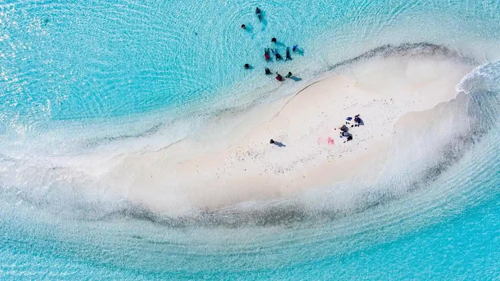 Aerial view of a white sandbar with boats moored nearby